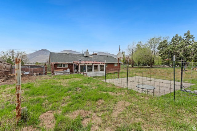 149 West 1600th Street South Mapleton, UT 84664 - Photo 42 of 44 Back of house with a fenced backyard, basketball court, and a patio area