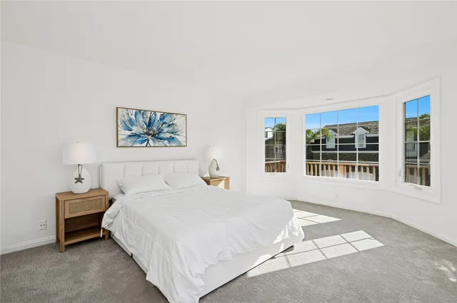 a bedroom with a bed and a night stand