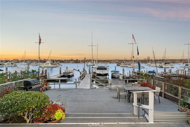 a view of a house with a table and chairs in patio