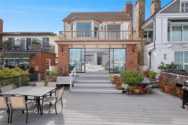 a view of a house with a chairs and table in a patio