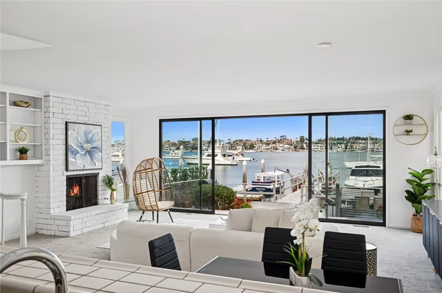 a living room with fireplace furniture and a floor to ceiling window