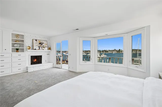 a spacious bedroom with a large bed and a large window