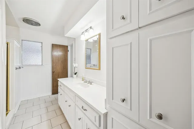 a bathroom with a double vanity sink and mirror
