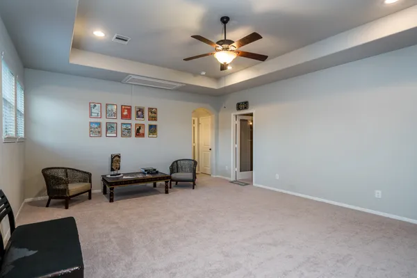 a view of a livingroom with furniture and a ceiling fan