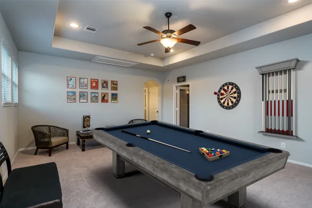 a living room with furniture and a pool table