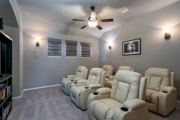 a living room with furniture ceiling fan and a window