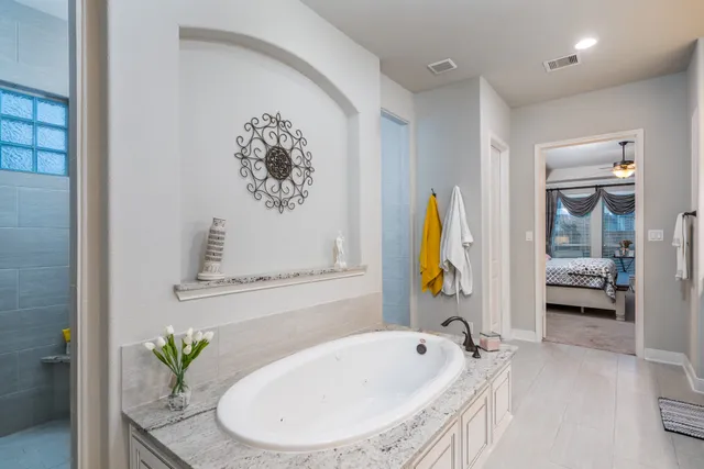 a bathroom with a tub and a sink