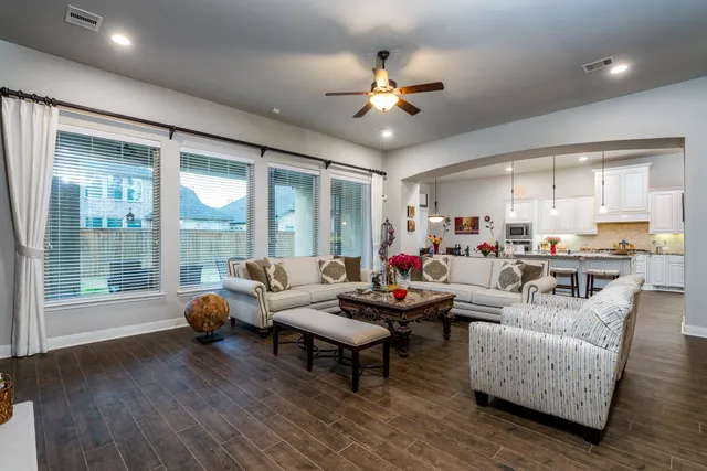 a living room with furniture and floor to ceiling window