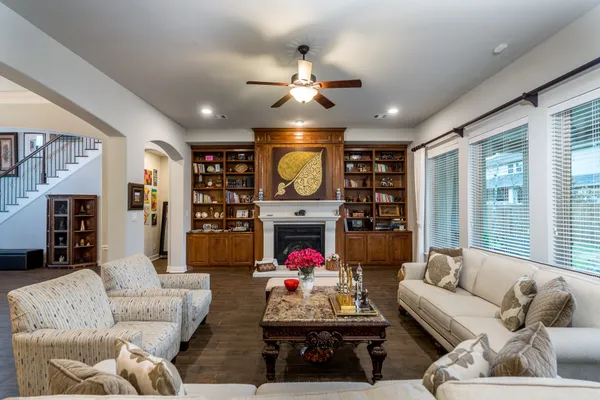 a living room with fireplace furniture and a chandelier