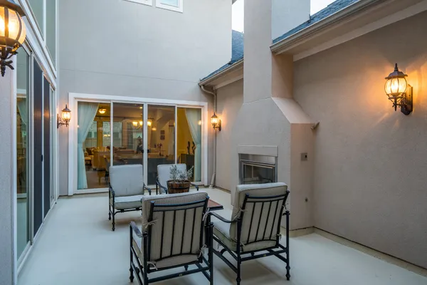 a view of a porch with furniture and fireplace