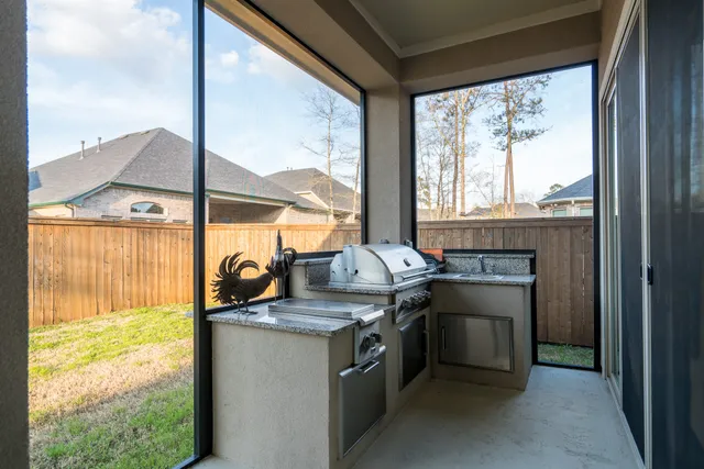a kitchen with stainless steel appliances granite countertop a stove and a next to a window