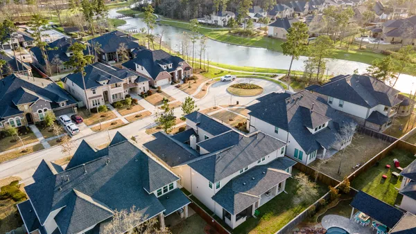 an aerial view of a house with swimming pool and outdoor space