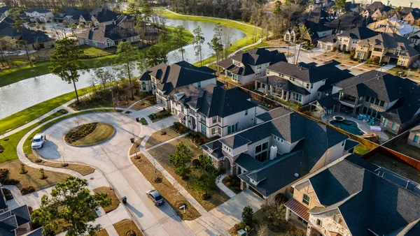 an aerial view of residential house with outdoor space and swimming pool