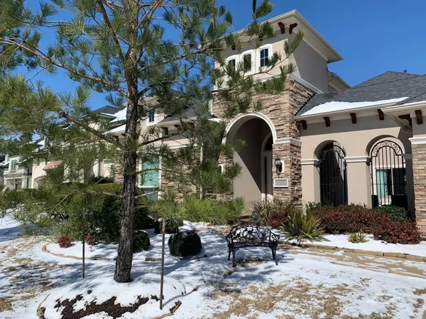a front view of a house with outdoor seating