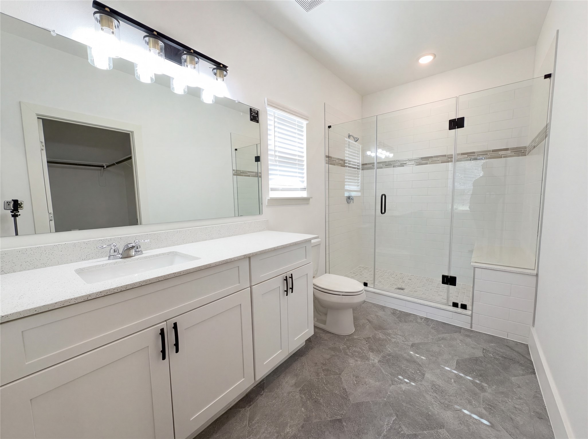 15376 Coaltown Road Willis, TX 77378 - Photo 11 of 17 a spacious bathroom with double sink a toilet a shower and a mirror