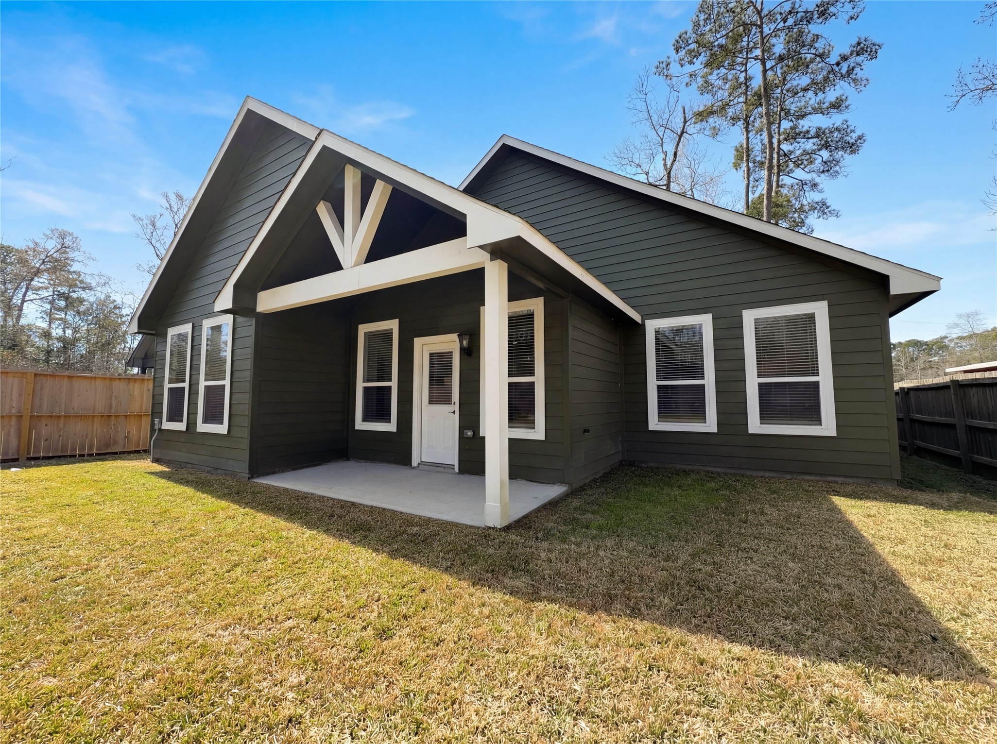 15376 Coaltown Road Willis, TX 77378 - Photo 16 of 17 a view of a house with wooden walls and yard