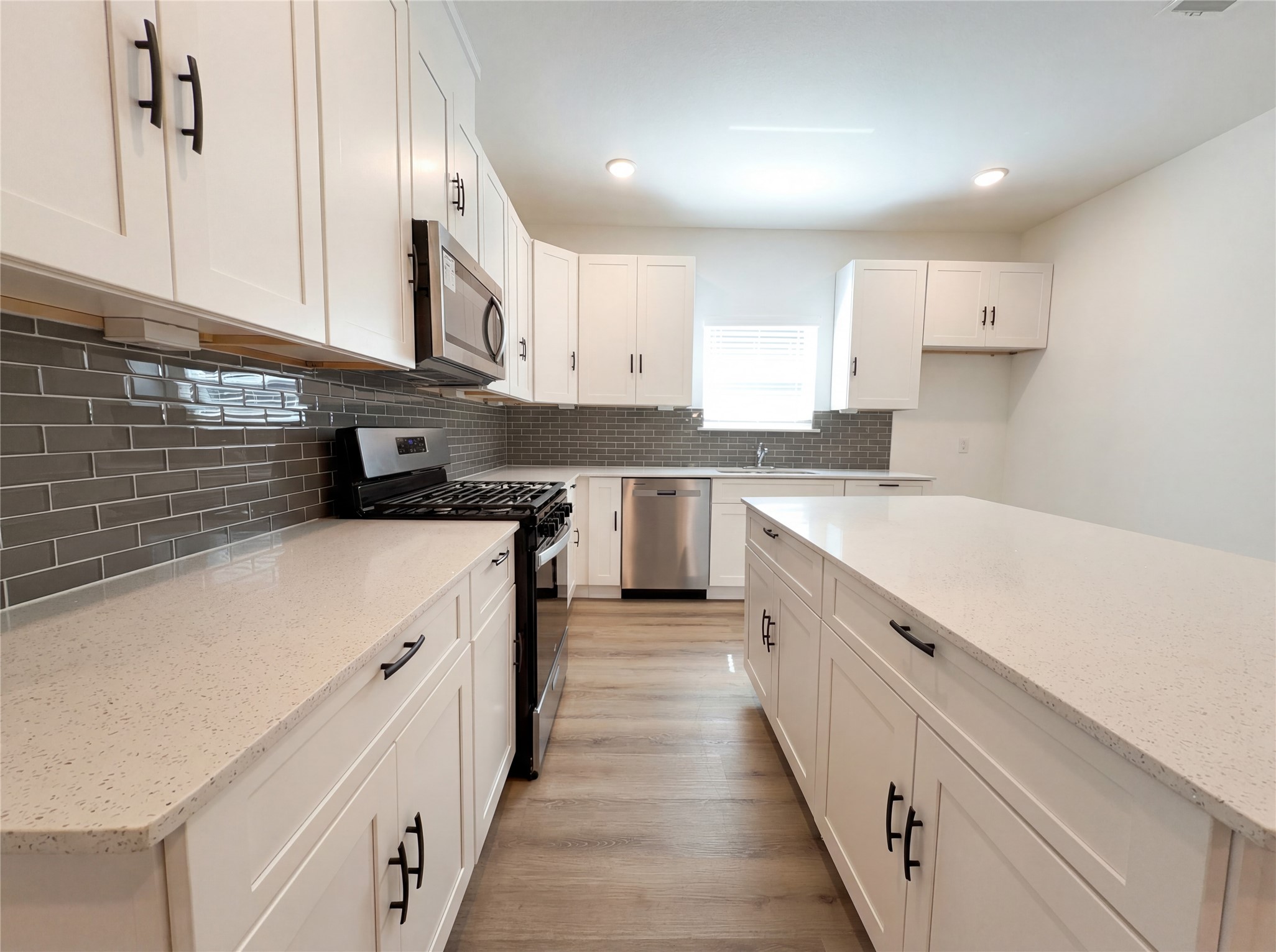 15376 Coaltown Road Willis, TX 77378 - Photo 2 of 17 a kitchen with stainless steel appliances a sink stove and cabinets