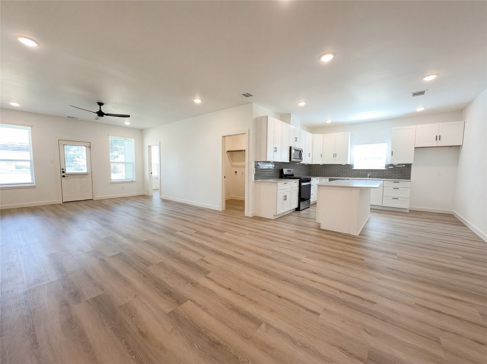 15376 Coaltown Road Willis, TX 77378 - Photo 8 of 17 a view of kitchen with cabinets and wooden floor