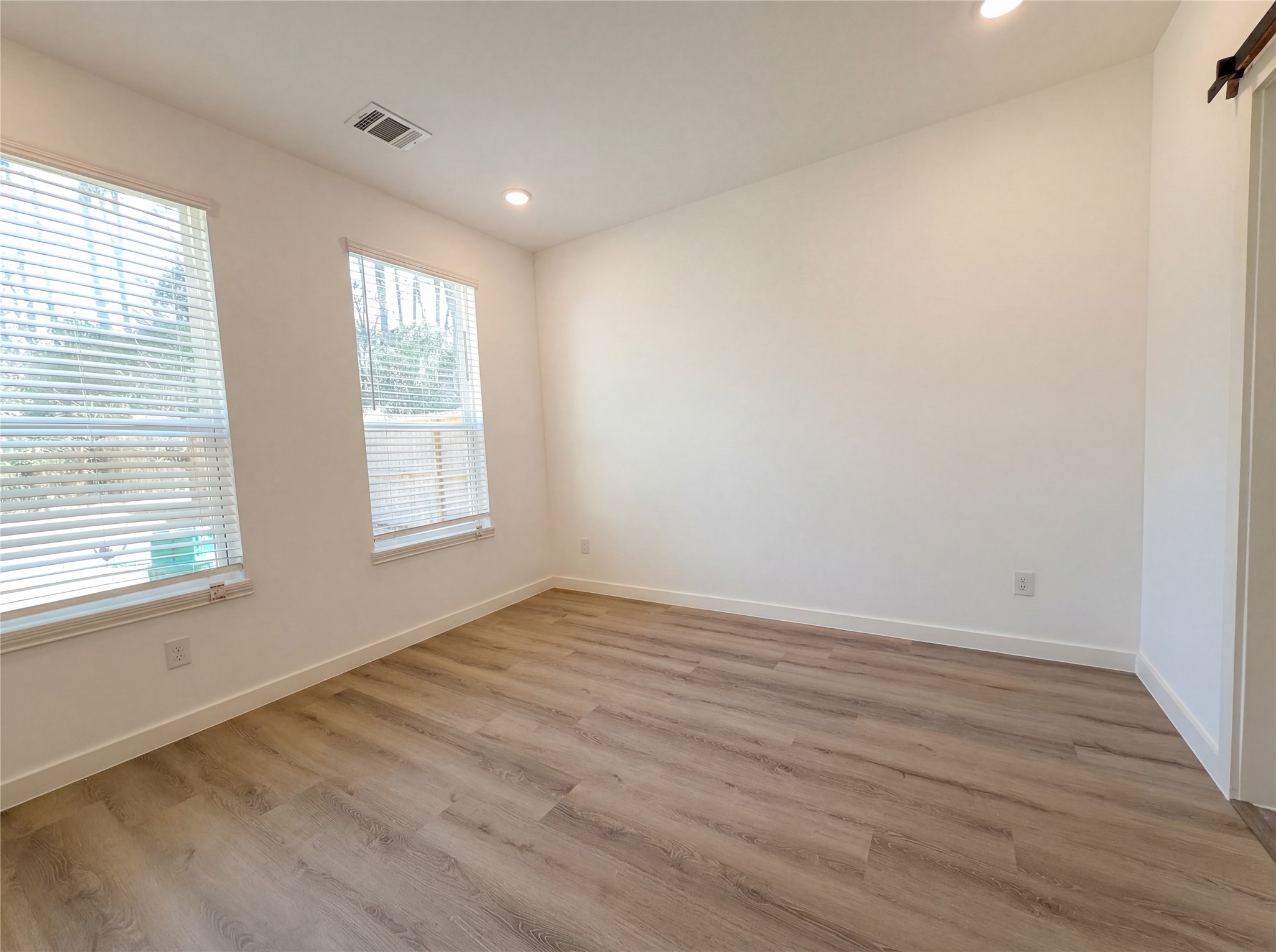 15376 Coaltown Road Willis, TX 77378 - Photo 10 of 17 a view of an empty room with wooden floor and a window