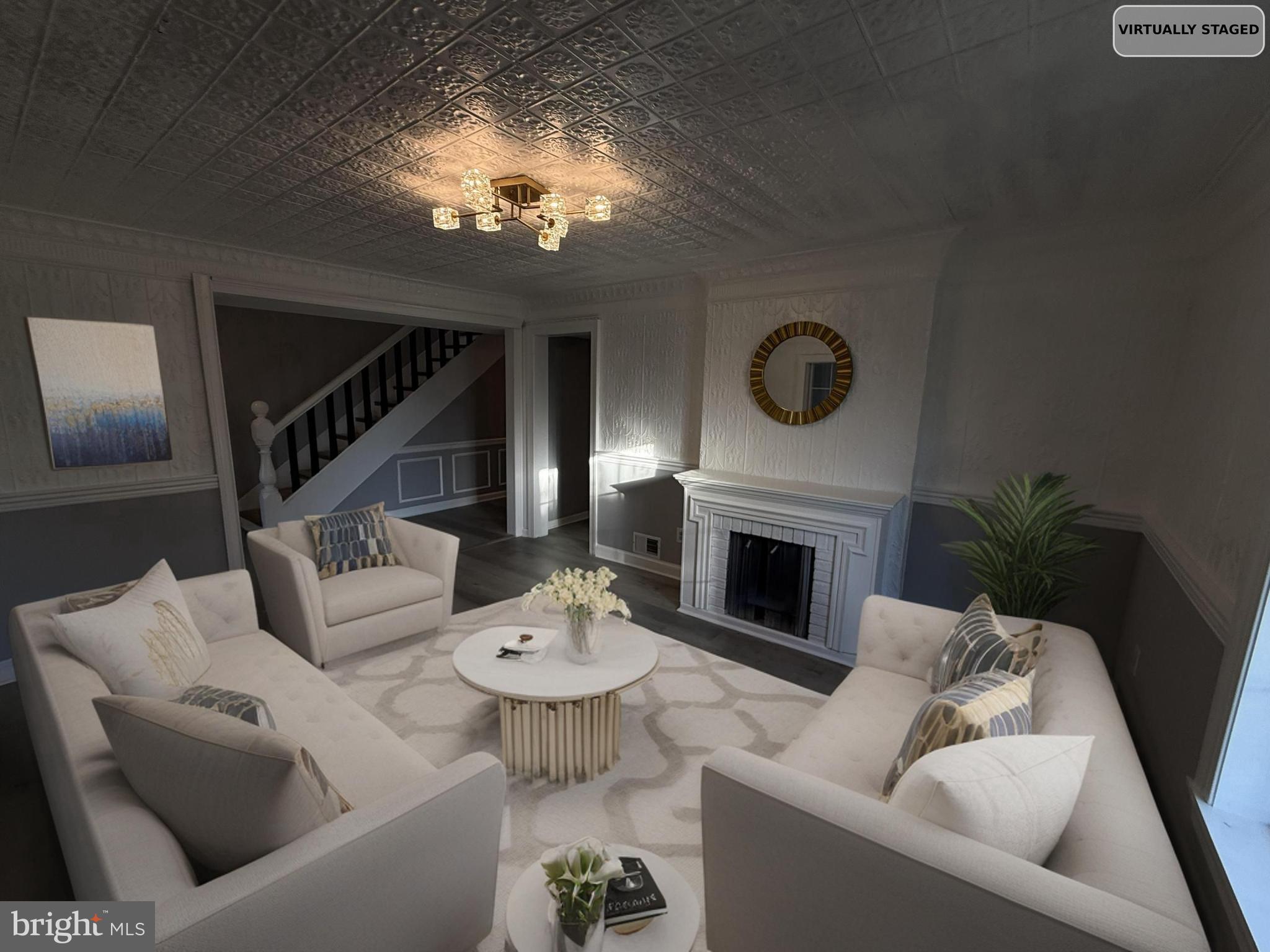 a living room with furniture a fireplace and a potted plant