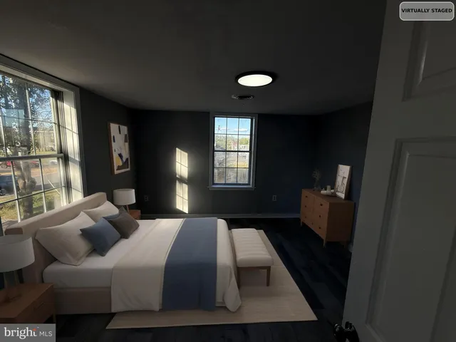 a bedroom with a bed window and a couch