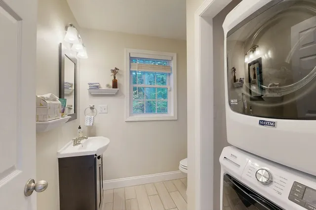a bathroom with a sink a toilet and mirror