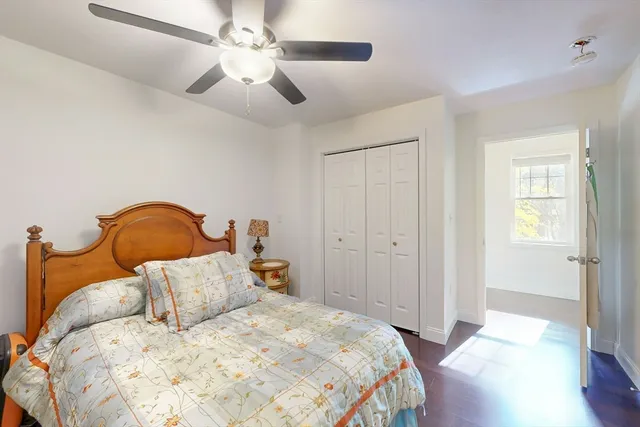 a bedroom with a bed and a ceiling fan