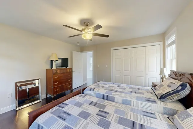 a bedroom with a bed and a tv on dresser