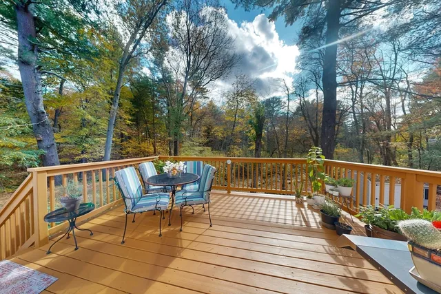 a view of a chairs on deck with wooden floor and fence
