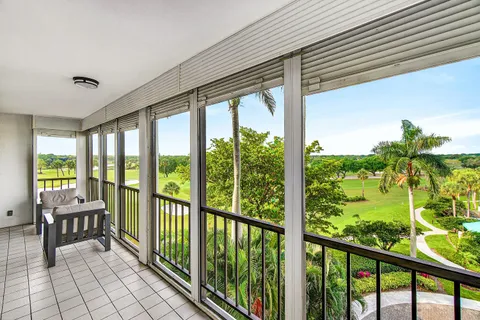 a view of a porch with furniture and floor to ceiling window