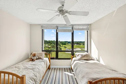 a bed sitting in a bedroom next to a window