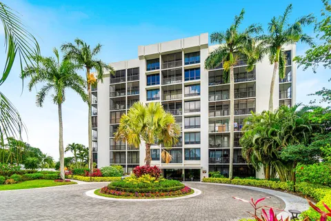 a front view of multi story residential apartment building with yard