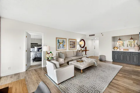 a living room with furniture and a wooden floor