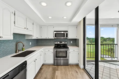 a kitchen with a sink a stove and cabinets