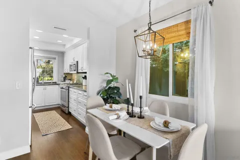 a kitchen with a table chairs sink and cabinets