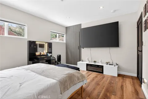 a bedroom with a bed and a flat screen tv