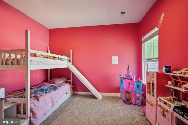 a front view of a residential apartment building with a yard