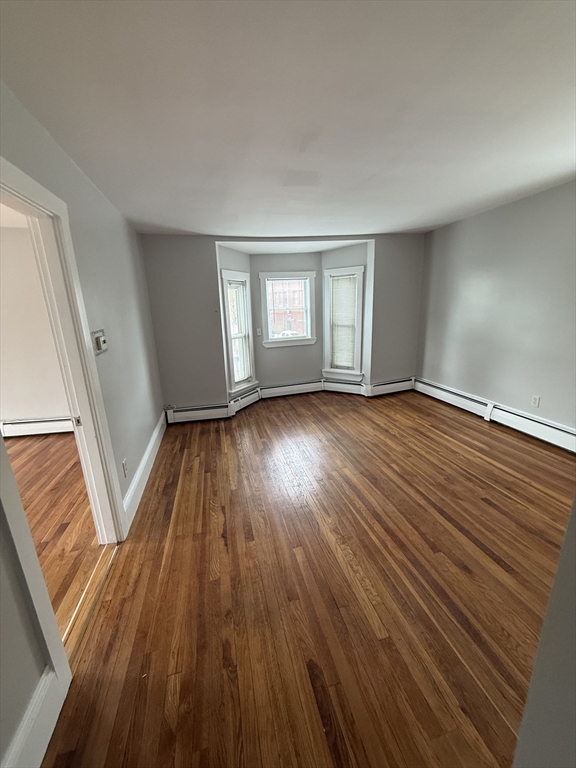 1 Jay Street, Unit 2 Cambridge, MA 02139 - Photo 1 of 14 an empty room with wooden floor and windows