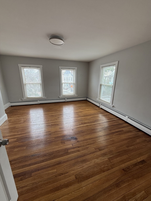 1 Jay Street, Unit 2 Cambridge, MA 02139 - Photo 3 of 14 an empty room with wooden floor and windows