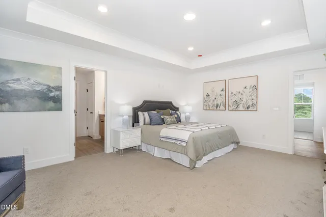 a spacious bedroom with a bed and a couch