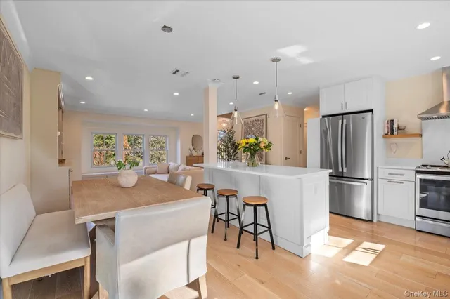 a kitchen with stainless steel appliances granite countertop a stove a refrigerator and a sink