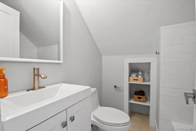 a bathroom with a sink a toilet and vanity