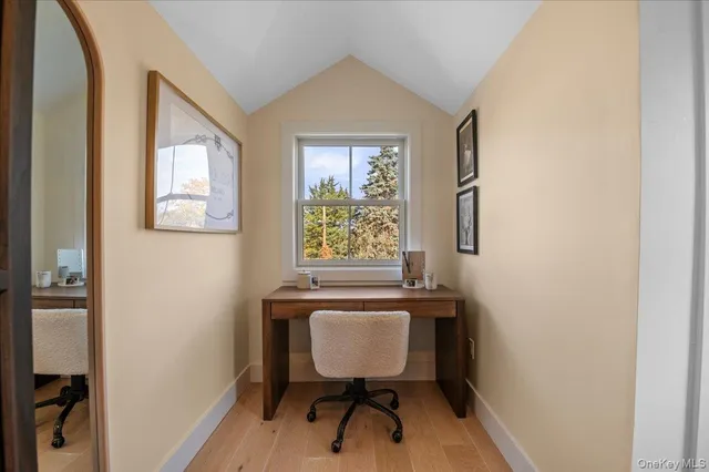 a view of a room with wooden floor and furniture