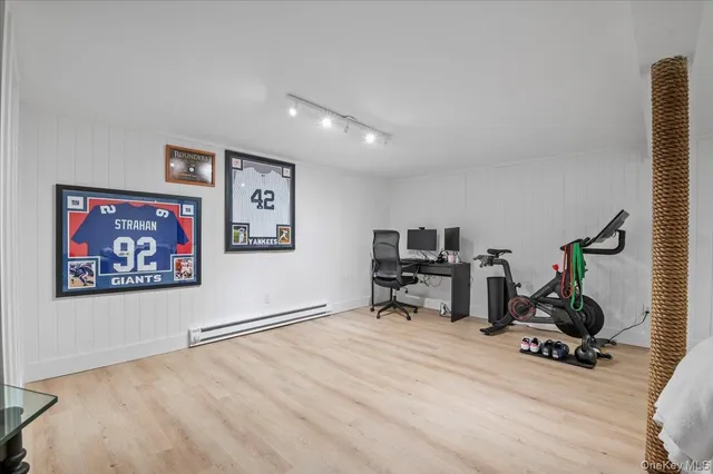 a view of a workspace with furniture and wooden floor