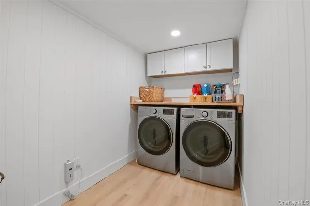 a utility room with sink dryer and washer