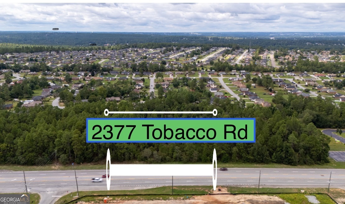 a view of a park with an ocean view