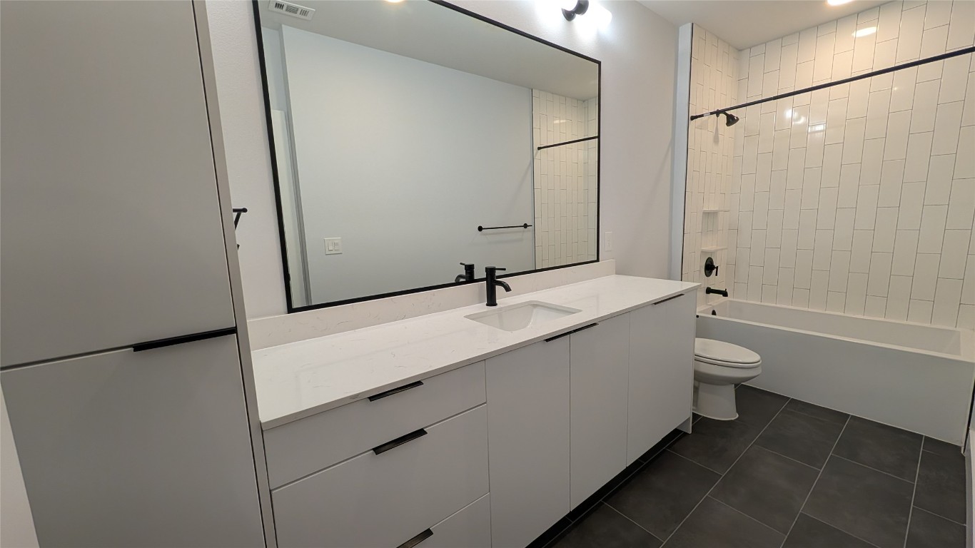 2500 Longview Street, Unit 218 Austin, TX 78705 - Photo 15 of 19 Bathroom 2with vanity, dark tile patterned flooring, shower combination, and recessed lighting