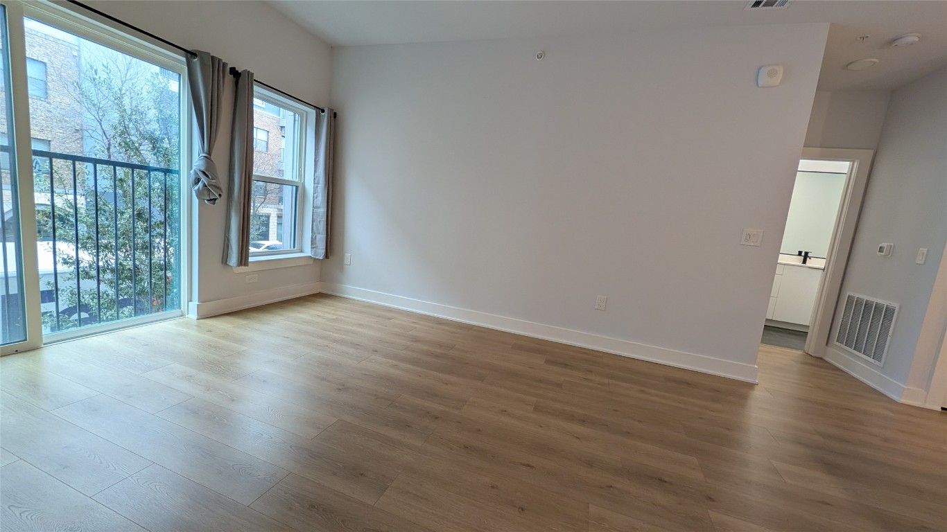2500 Longview Street, Unit 218 Austin, TX 78705 - Photo 6 of 19 Living room featuring wood finished floors and baseboards
