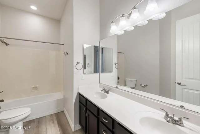a bathroom with a bathtub a sink and a mirror
