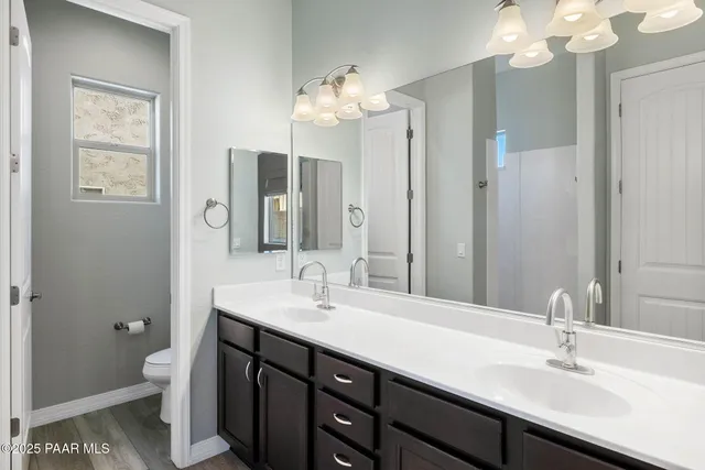 a bathroom with a double vanity sink mirror and vanity